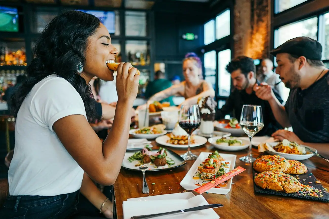 Friends sharing dishes around a restaurant table
